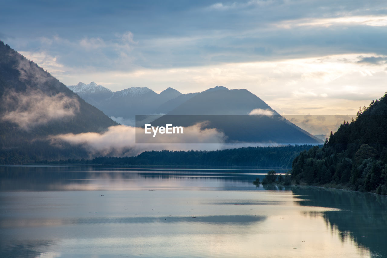 Scenic view of lake and mountains against sky