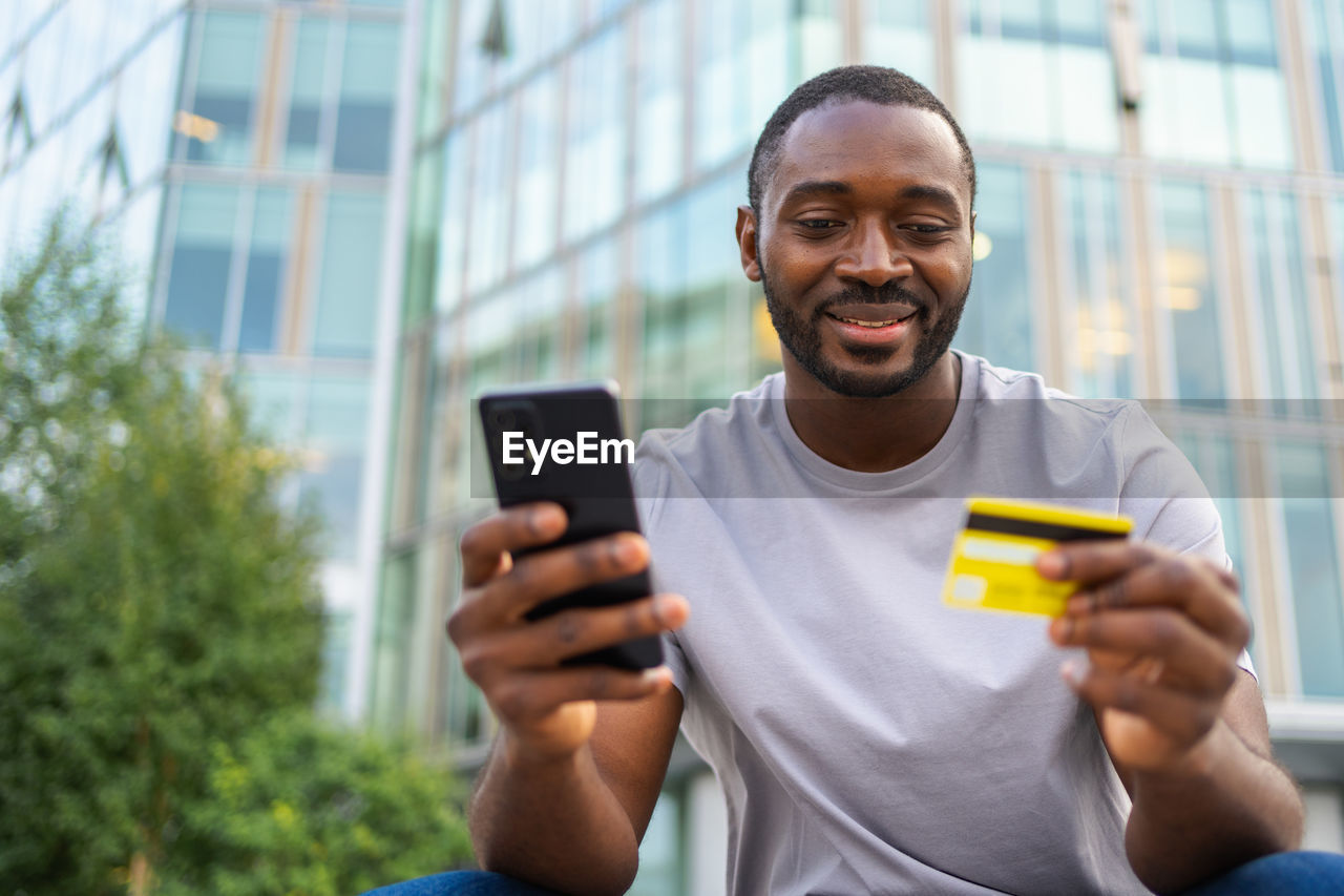 portrait of young man using mobile phone