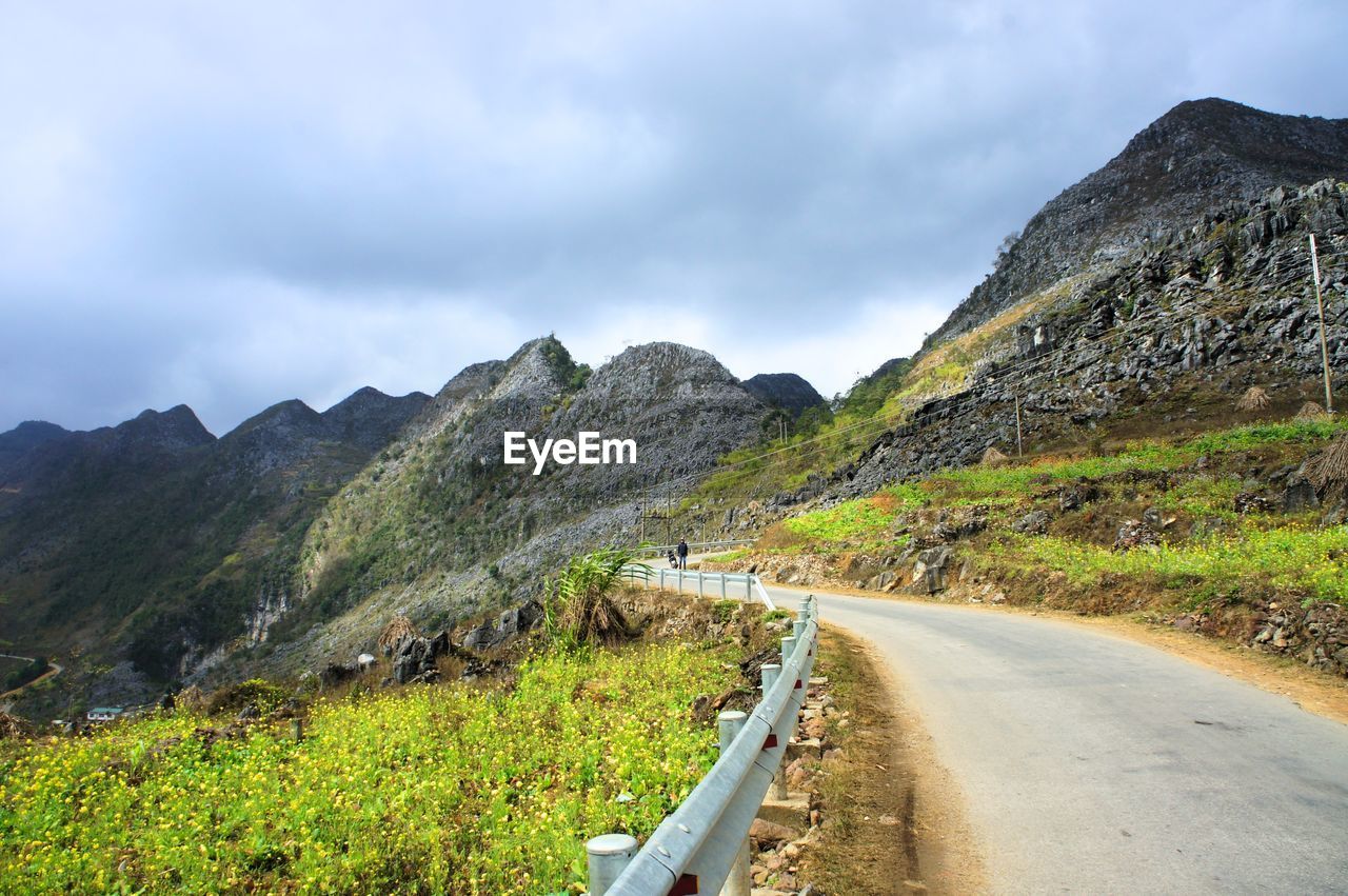 Road amidst mountains against sky