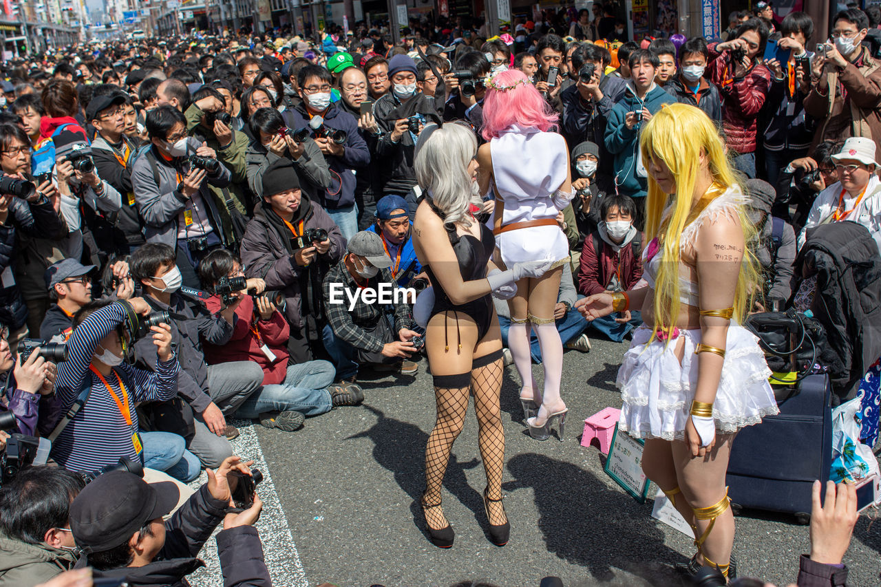 HIGH ANGLE VIEW OF PEOPLE ON STREET