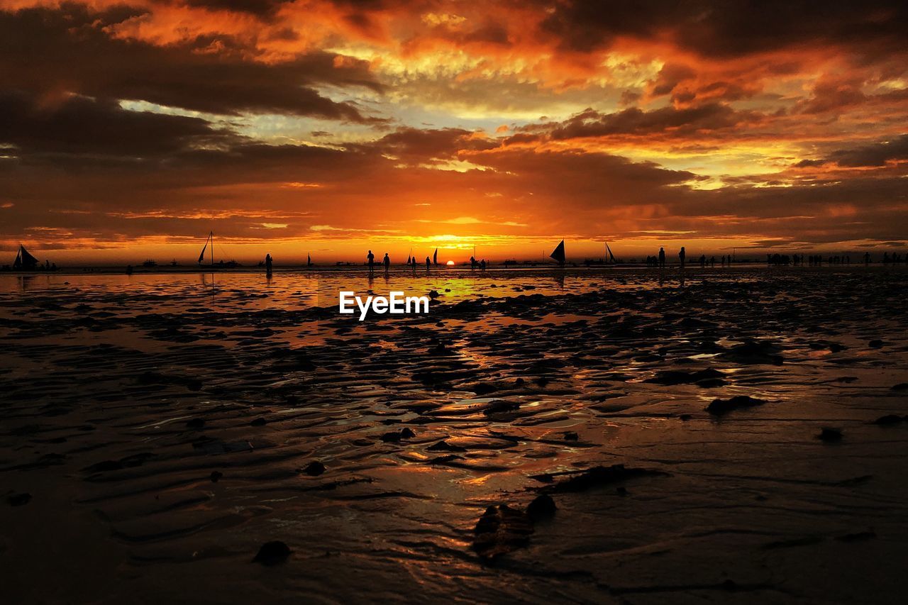 Scenic view of beach against sky during sunset