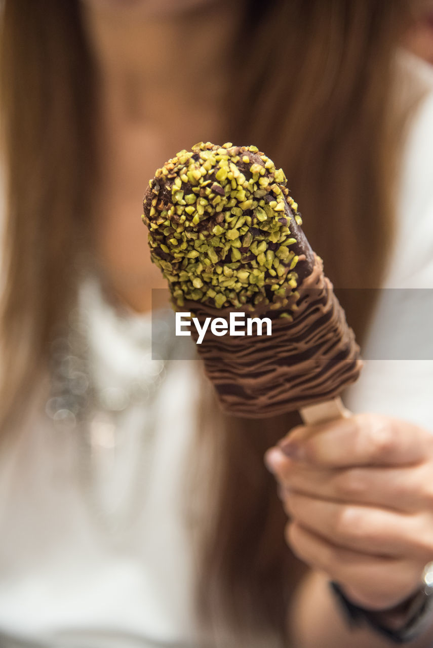 Close-up of woman holding chocolate ice cream