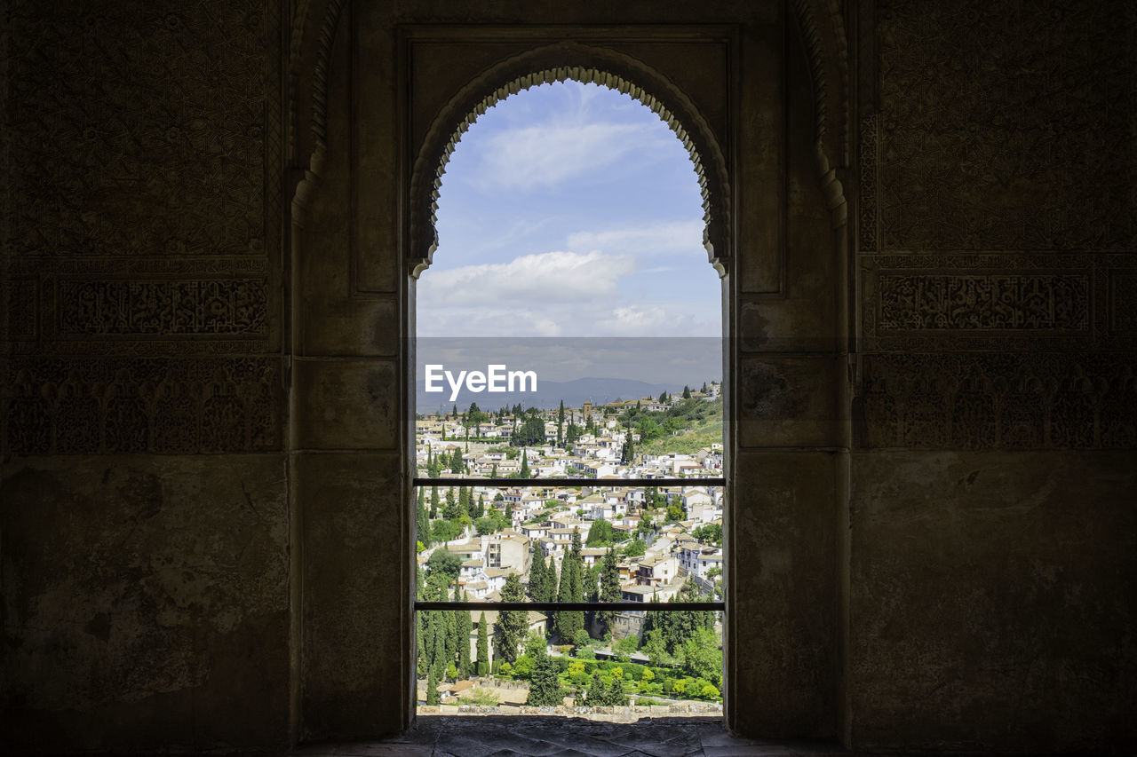 View of albaicín through an ornate doorway - granada, spain