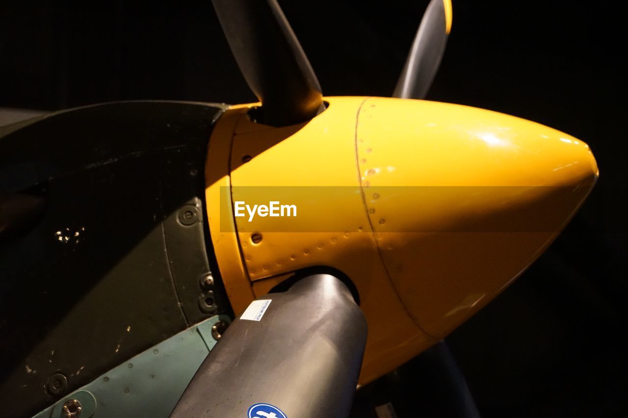 Low angle view of propeller against black background