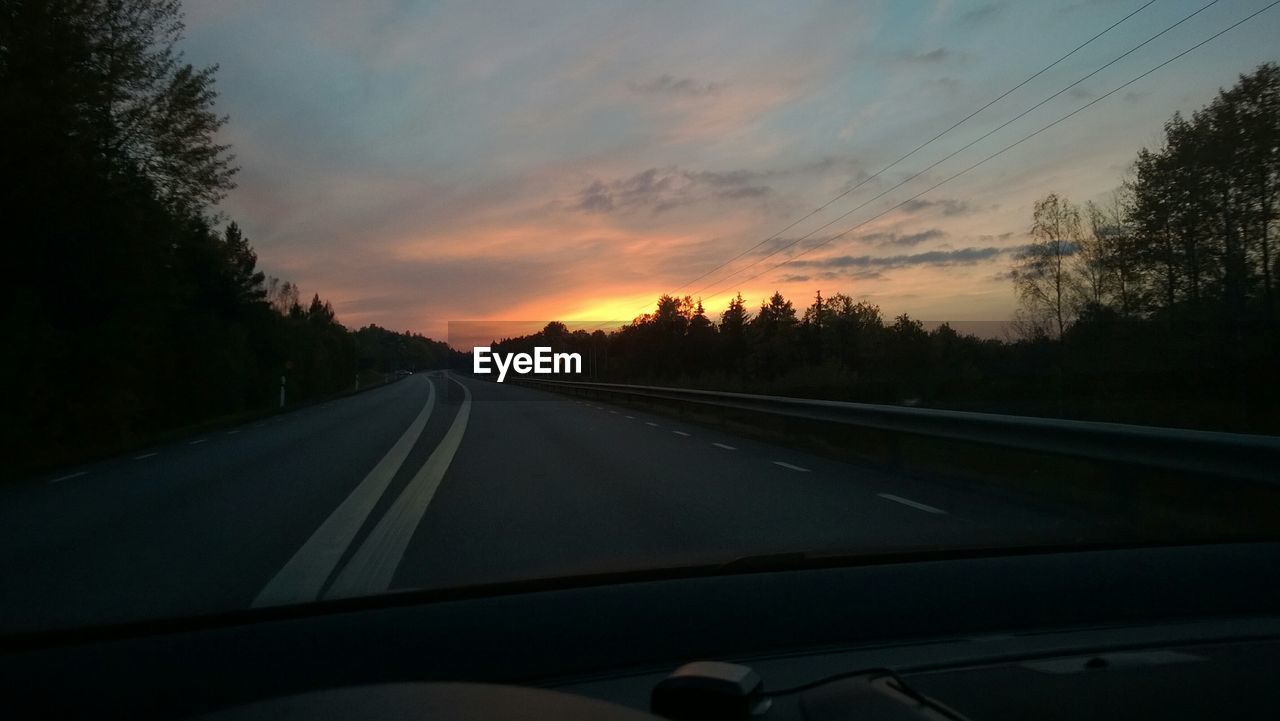 VIEW OF ROAD THROUGH CAR WINDSHIELD