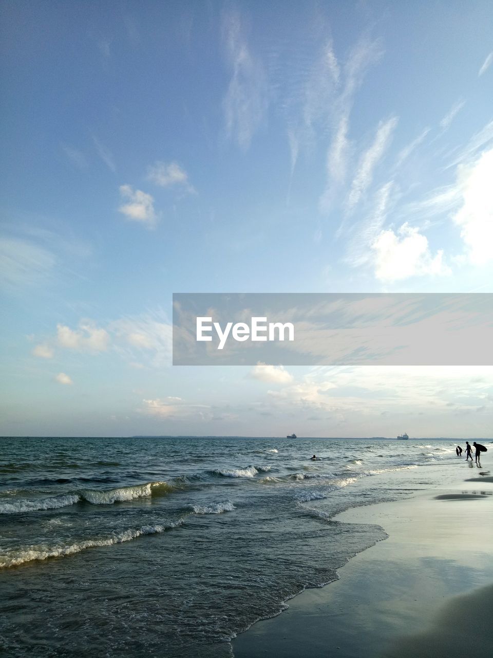 Scenic view of beach against cloudy sky