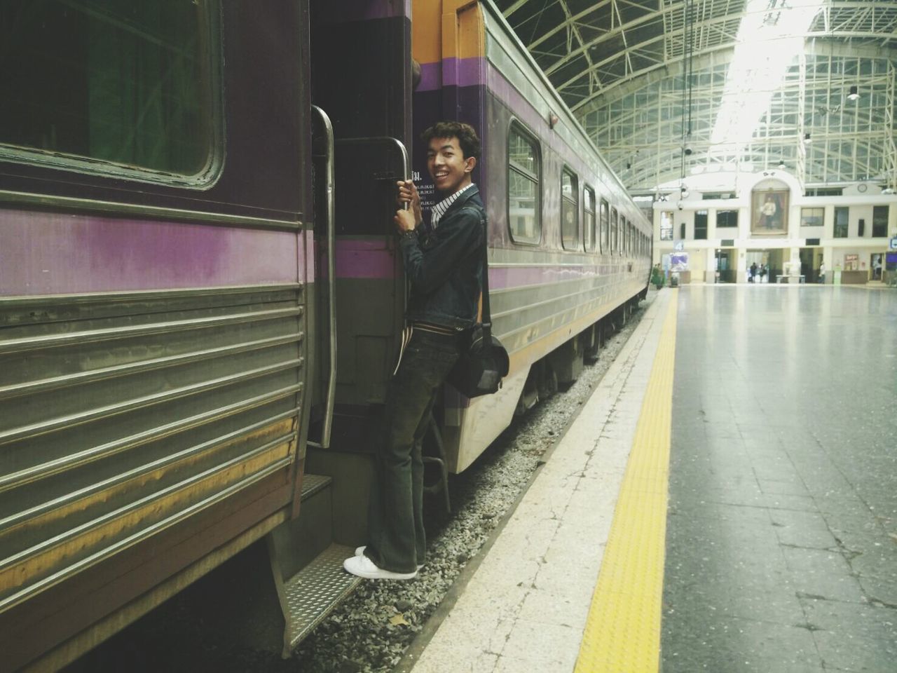 Young man catching train at railroad station
