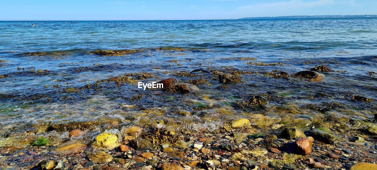 water, sea, rock, shore, land, body of water, beauty in nature, coast, beach, sky, nature, ocean, scenics - nature, horizon over water, horizon, tranquility, no people, wave, tide pool, day, tranquil scene, motion, outdoors, idyllic, wind wave, natural environment, environment, non-urban scene