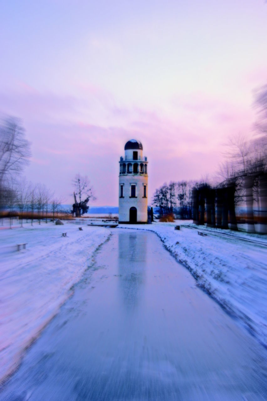 Lighthouse with snow at dusk