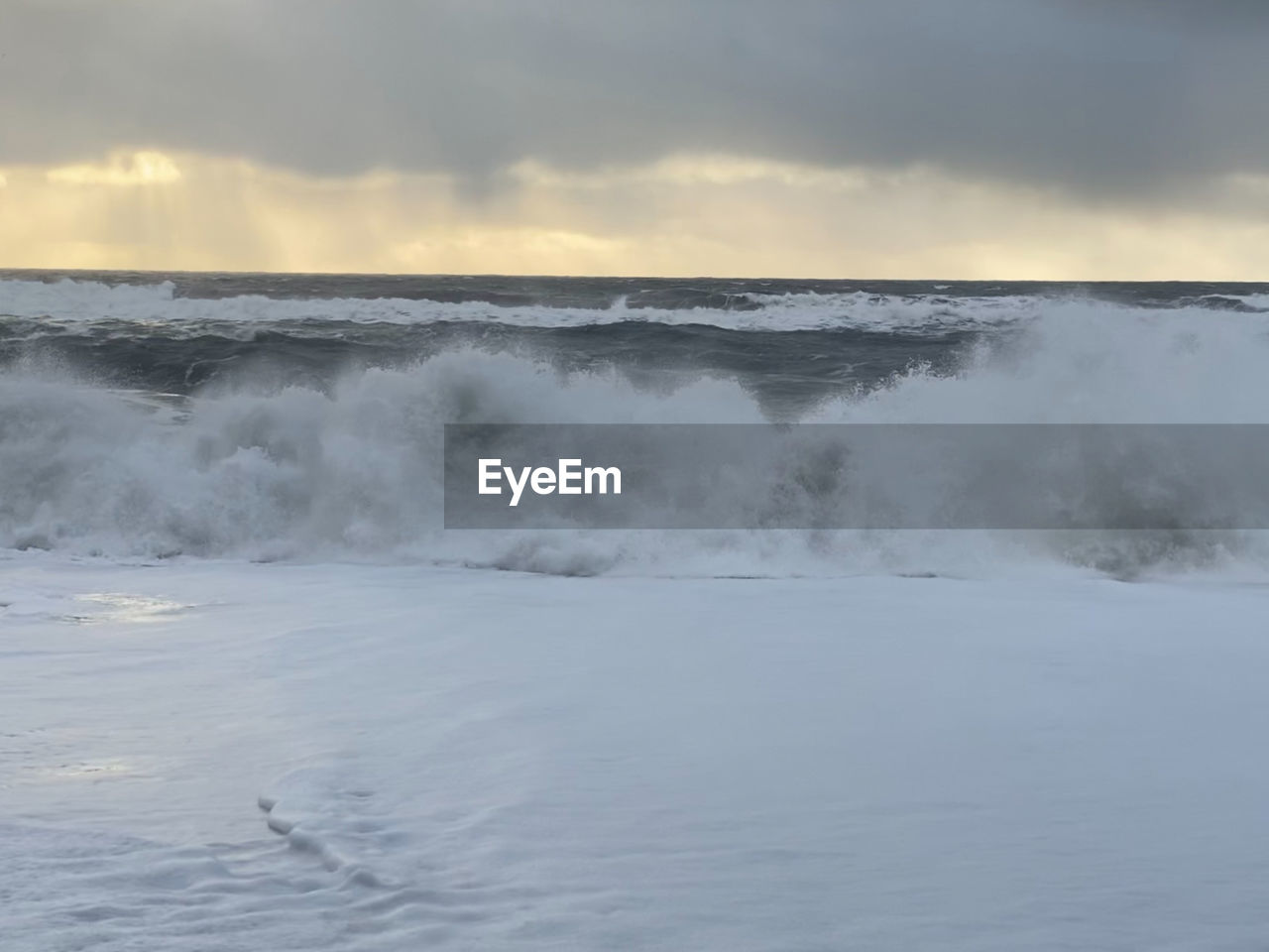 SCENIC VIEW OF WAVES BREAKING AGAINST SKY