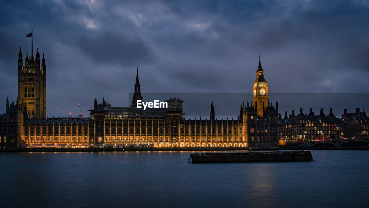 Big ben against cloudy sky at evening