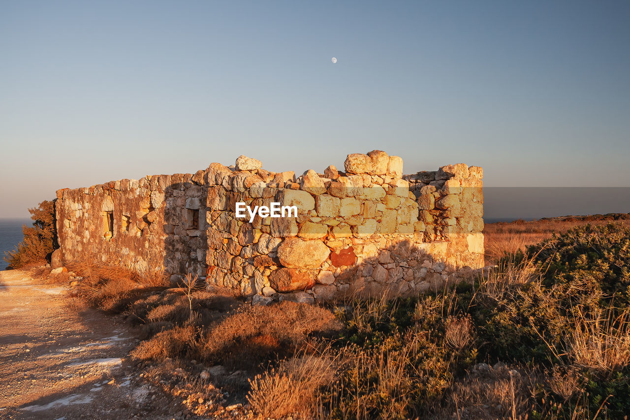 Abandoned house on the coast of milos island, cyclades, greece