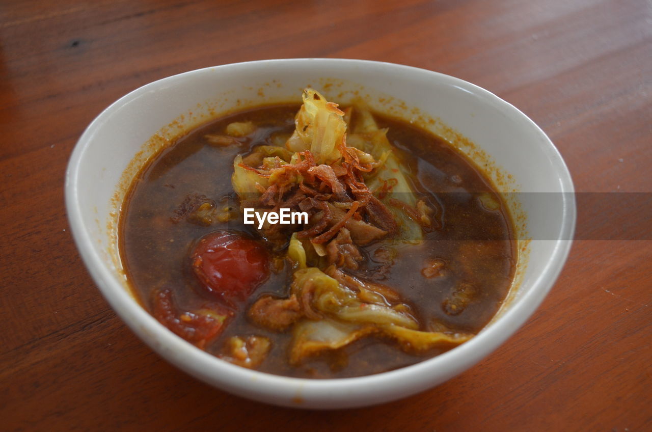 CLOSE-UP OF SOUP SERVED ON TABLE