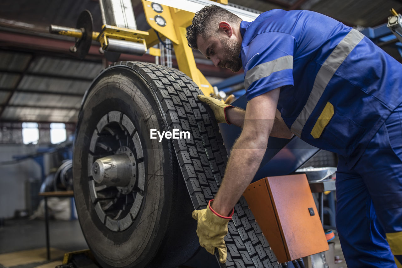 Tire repairer applying tire tread