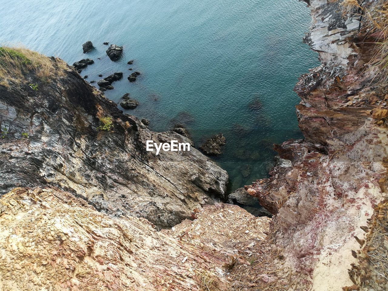 High angle view of rocks on sea shore