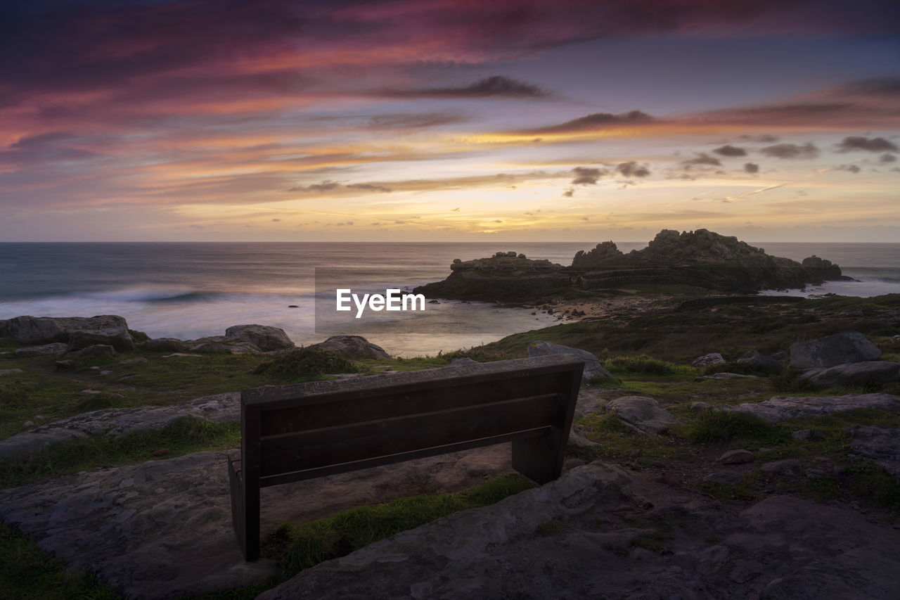 Bench with wonderful views of some ancient ruins on the coast