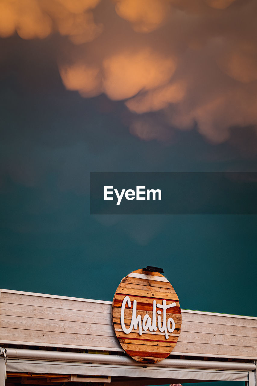 blue, sky, cloud, reflection, nature, no people, wood, morning, text, communication, water, architecture, outdoors, western script, sea, sign