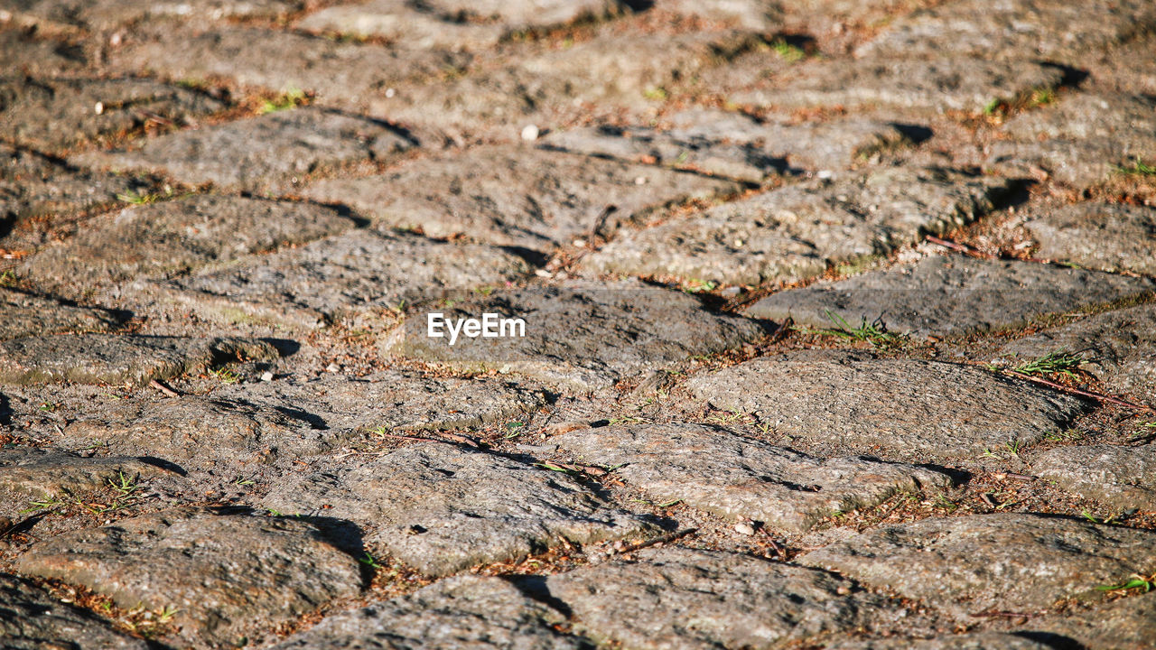 KopfSteinPflaster Backgrounds Close-up Cobblestones Cobblestones Background Texture Solution Cobblestonestreets Cracked Dry Full Frame High Angle View Natural Pattern Nature No People Pattern Rough Selective Focus Solid Street Sunlight Textured