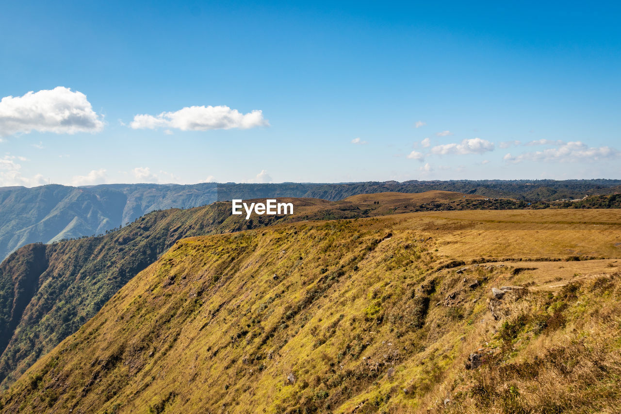 Misty mountain range covered with white mist and amazing blue sky