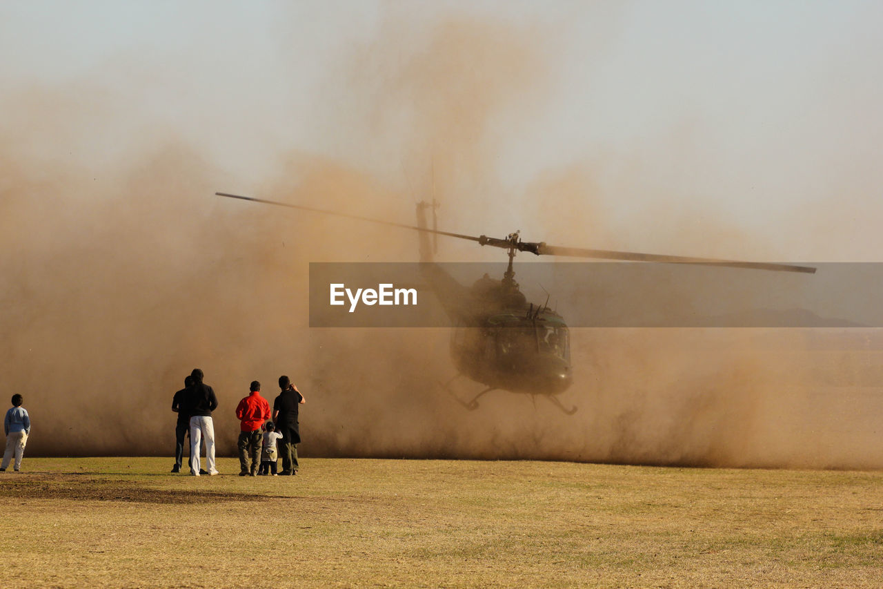 People looking at helicopter