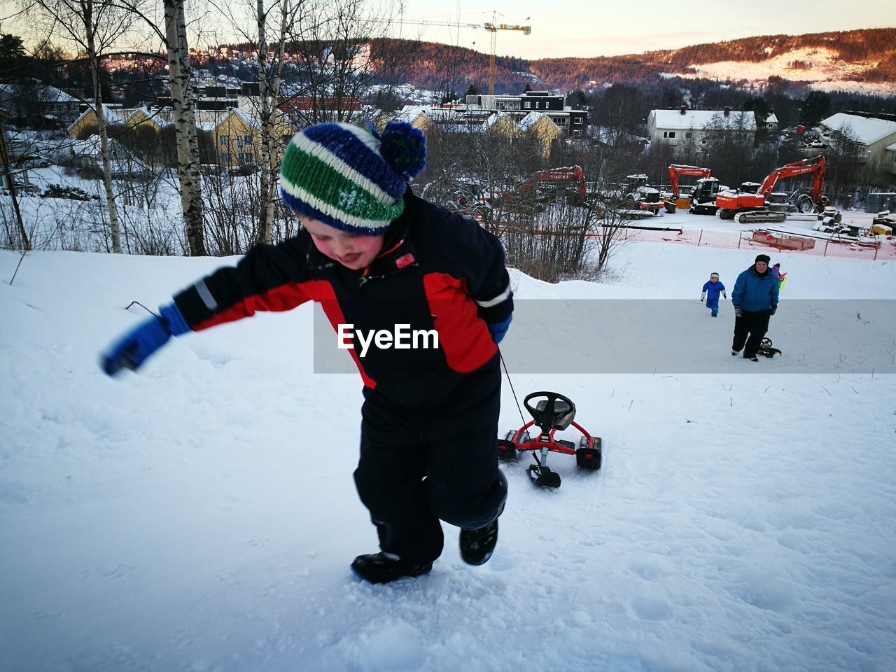 BOY PLAYING WITH SNOW