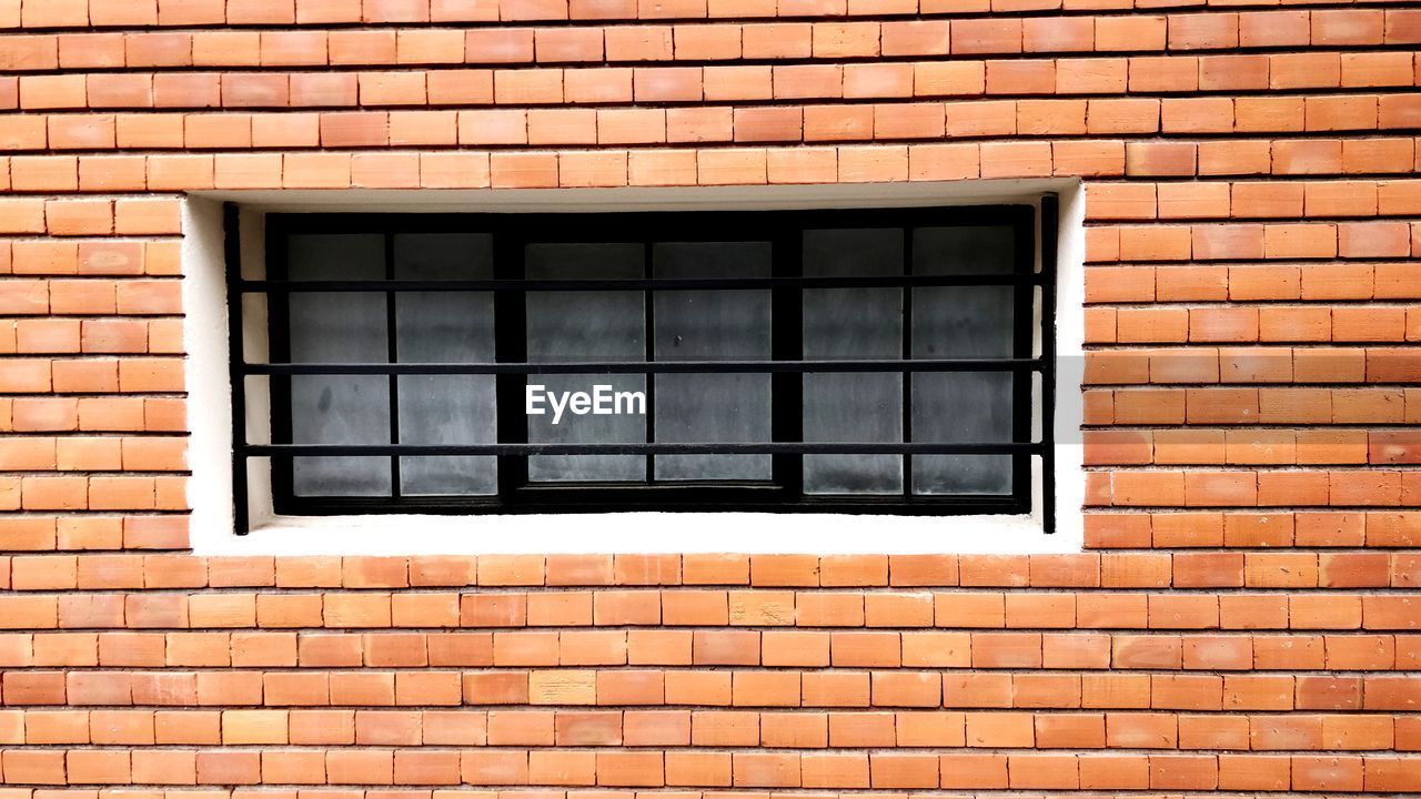 Close-up of window on brick wall