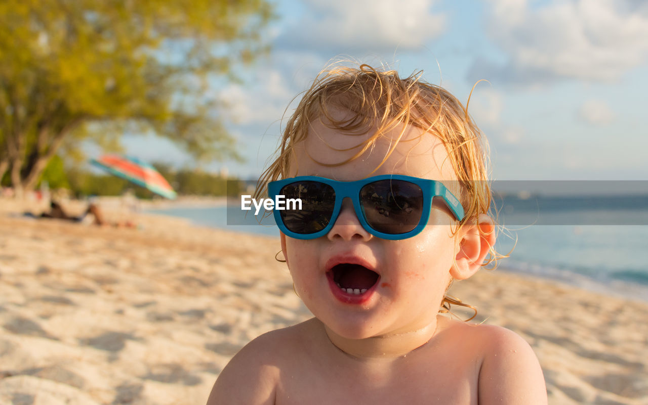 PORTRAIT OF SHIRTLESS BOY WEARING SUNGLASSES