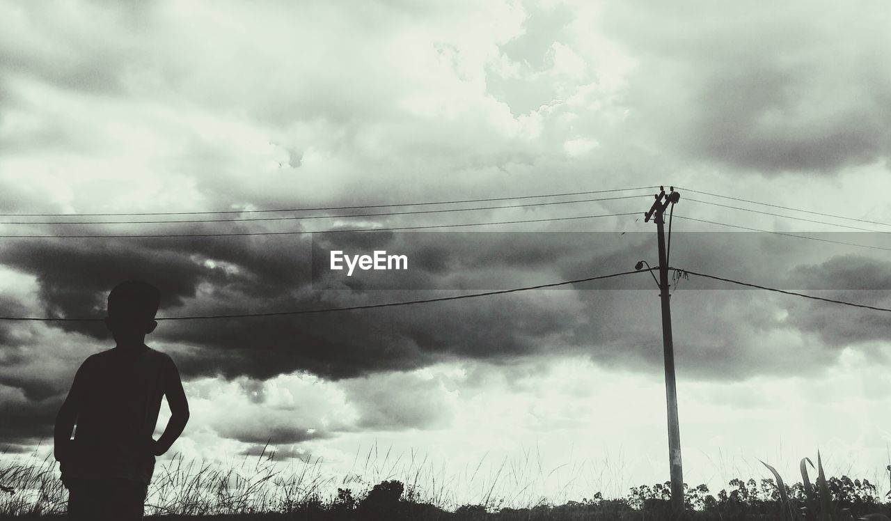 LOW ANGLE VIEW OF POWER LINES AGAINST CLOUDY SKY