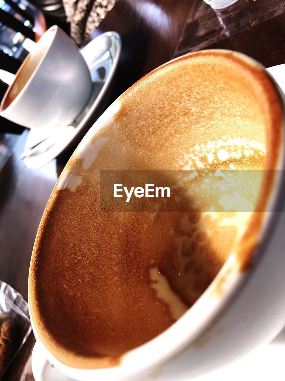 Close-up of messy coffee cups on restaurant table