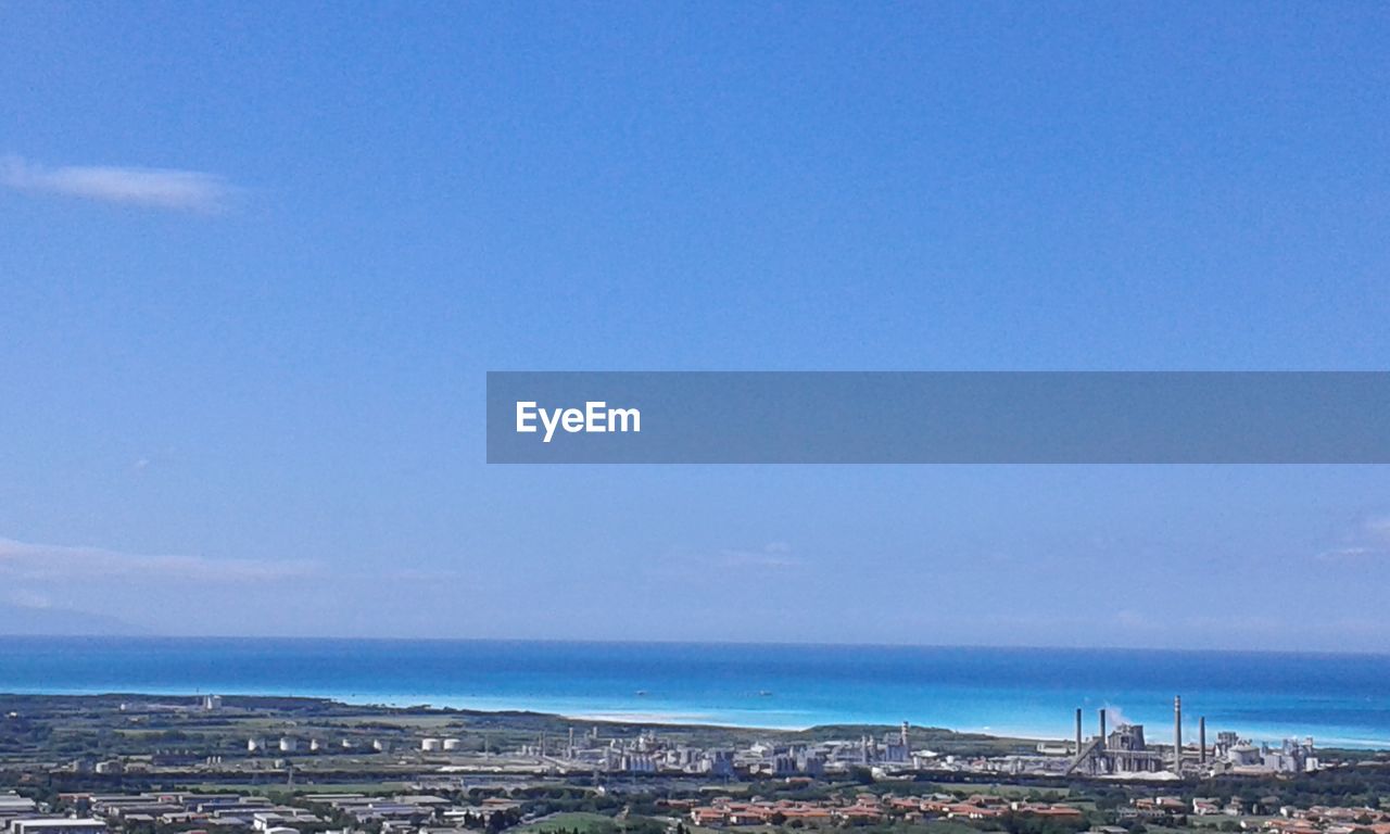 VIEW OF CITYSCAPE WITH SEA IN BACKGROUND