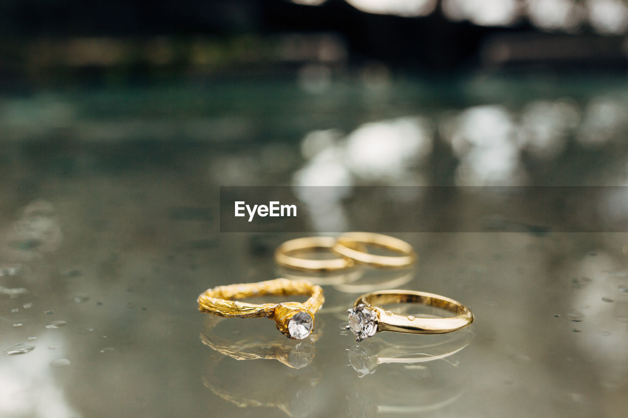 Close-up of wedding rings on glass