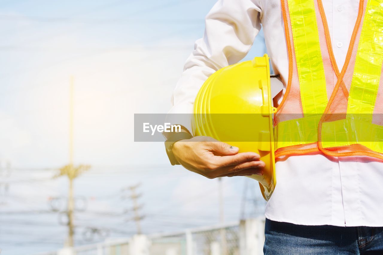 MAN WORKING WITH YELLOW UMBRELLA