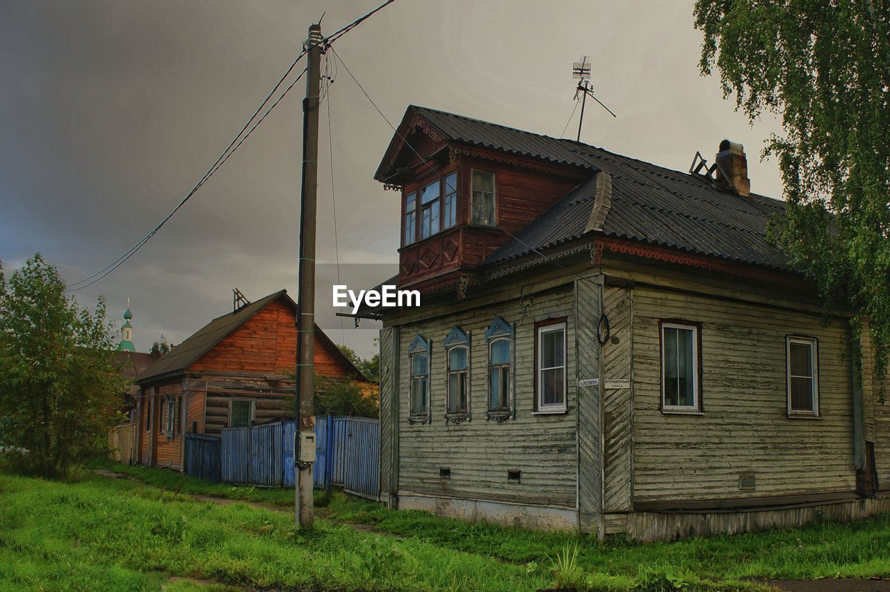 An old house on field against sky