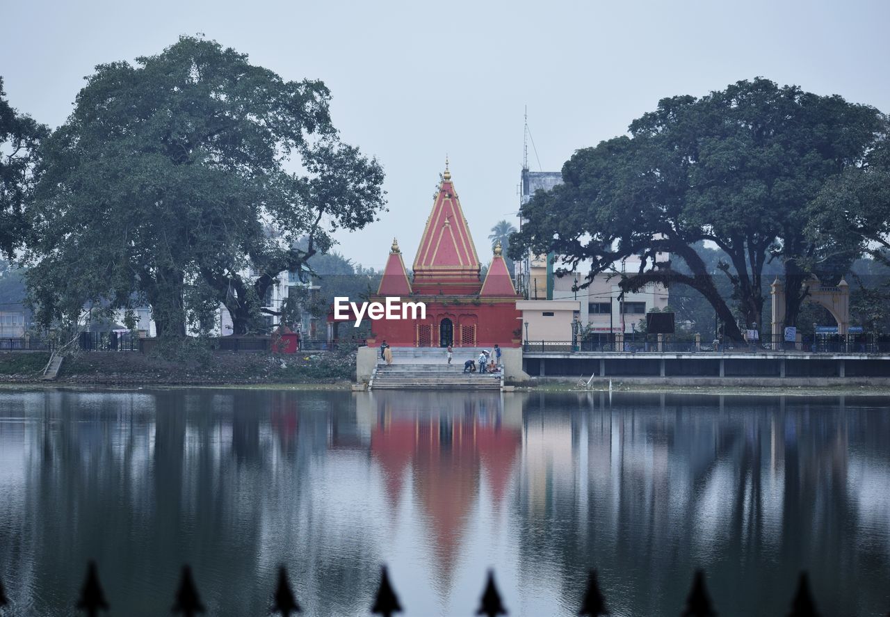 Panoramic view of lake by building against sky