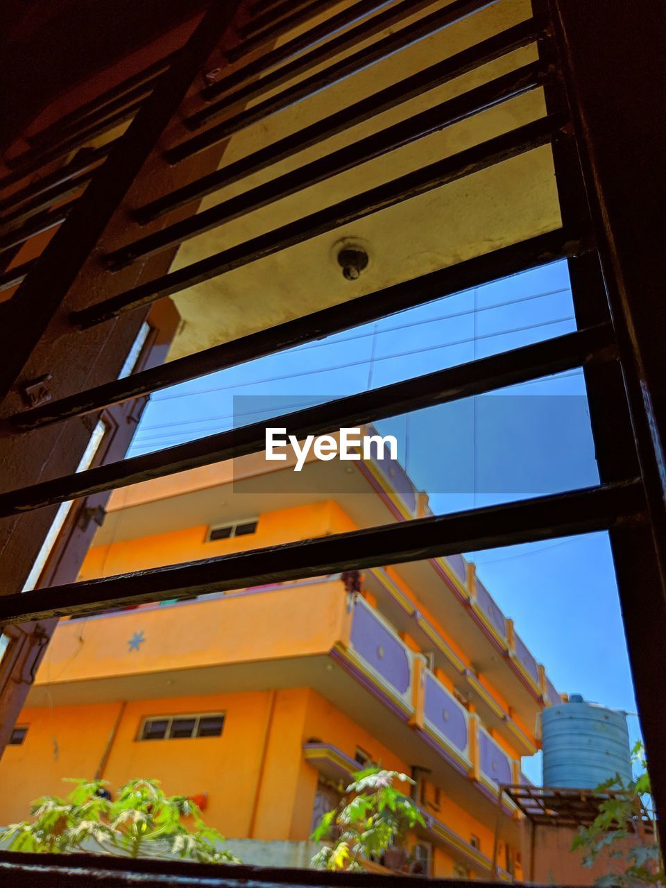 LOW ANGLE VIEW OF YELLOW BUILDING AGAINST SKY