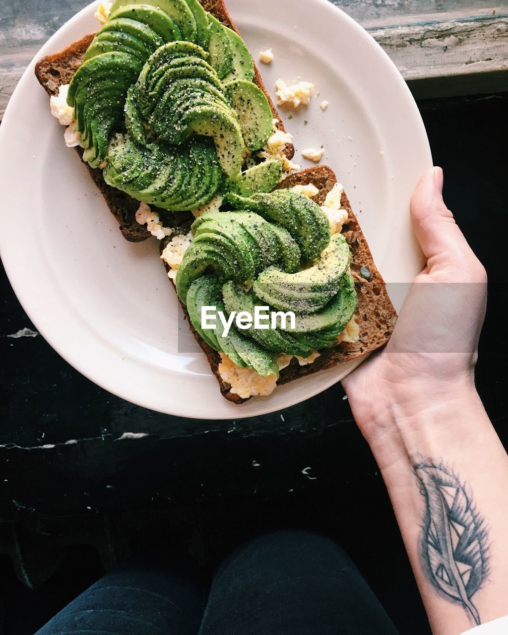 Cropped hand of woman holding food in plate