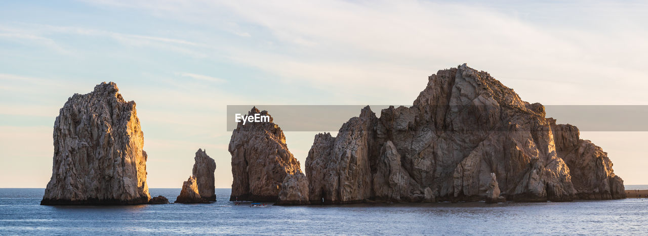 ROCK FORMATION IN SEA AGAINST SKY