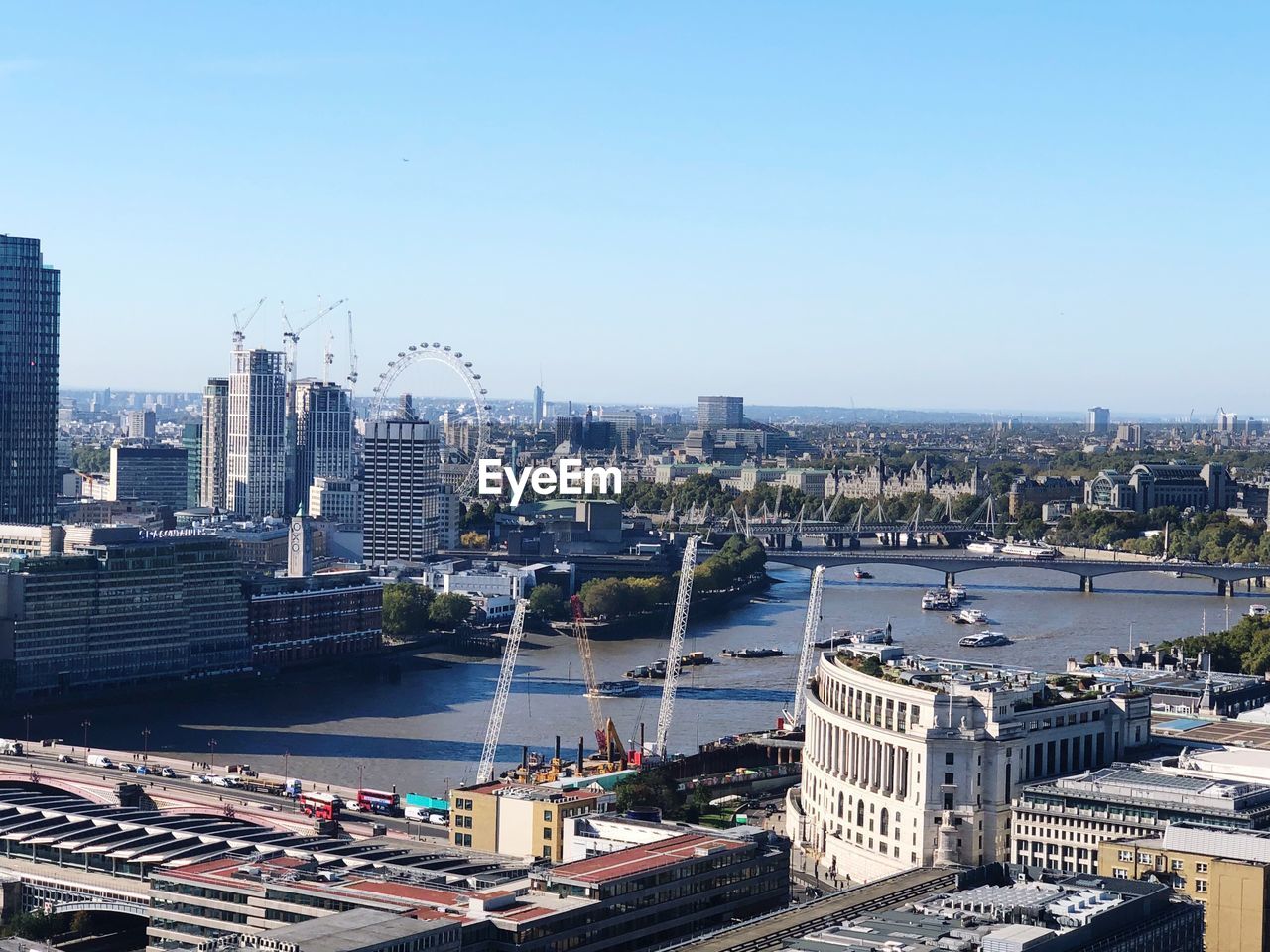 High angle view of river and buildings against clear sky