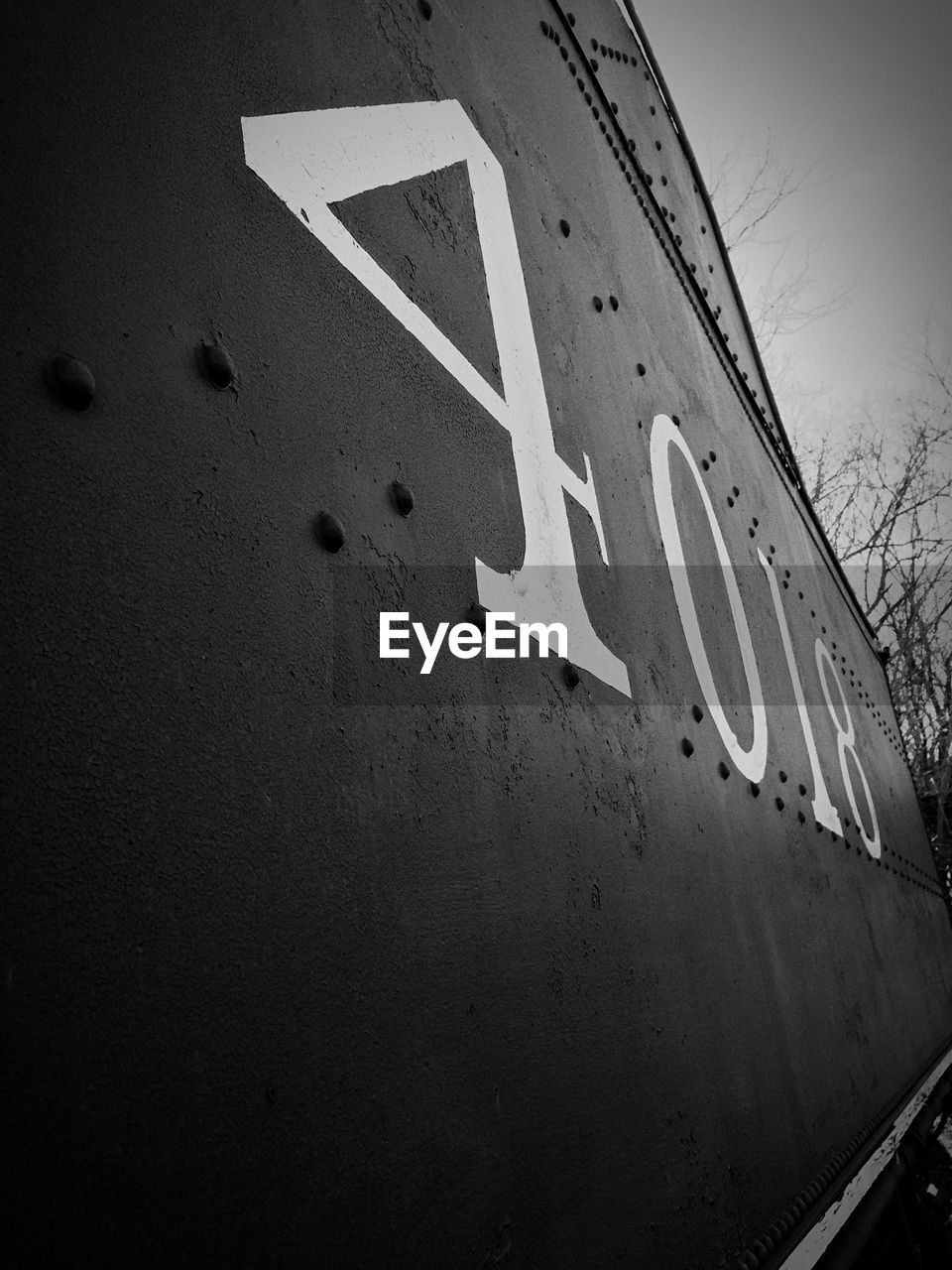 Low angle view of numbers on train against sky