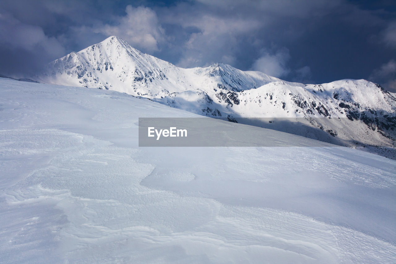 Scenic view of snow mountains against sky