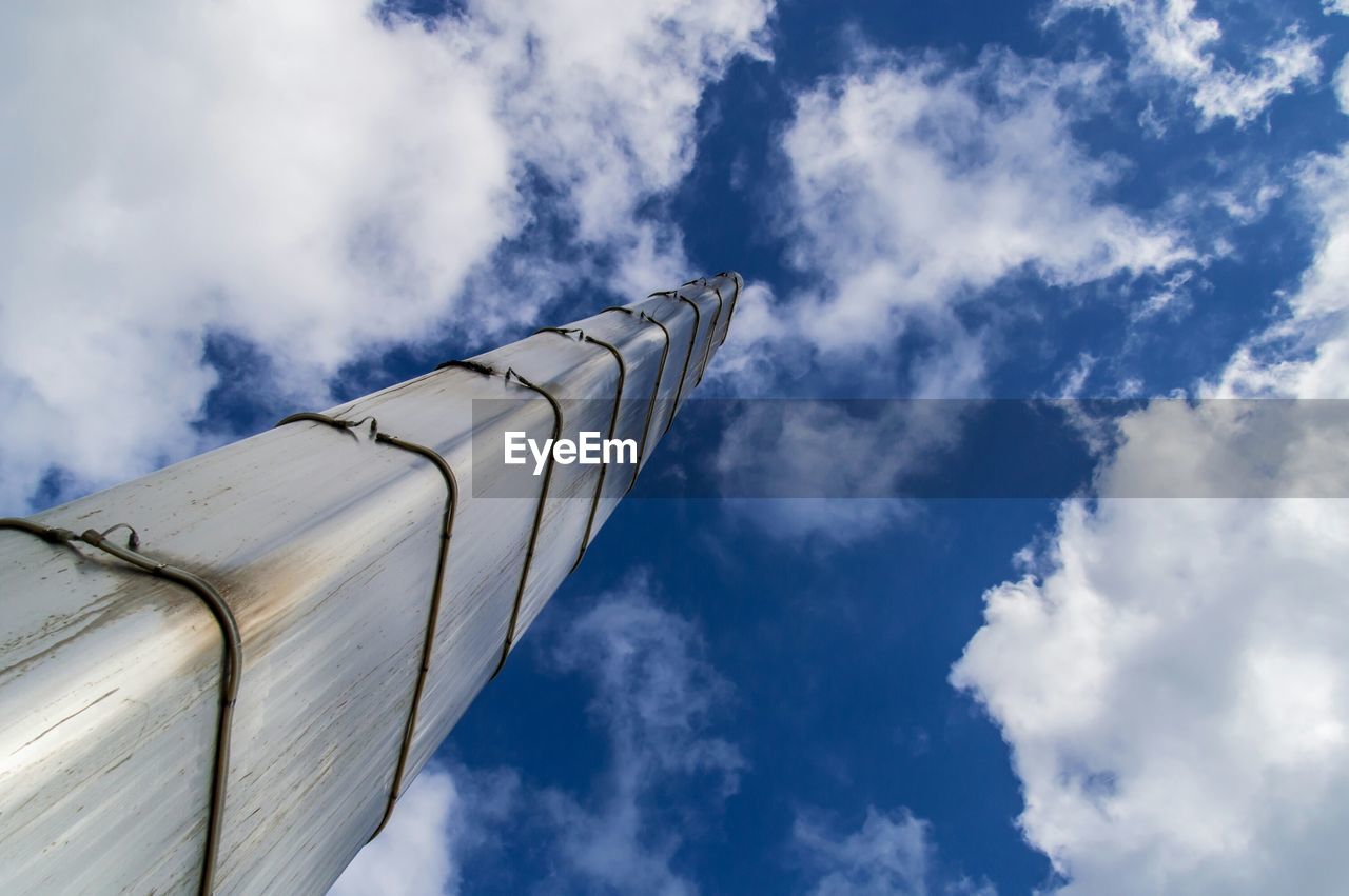 Low angle view of metallic structure against cloudy sky