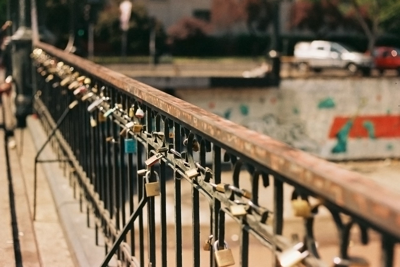 Padlocks locked on bridge railing