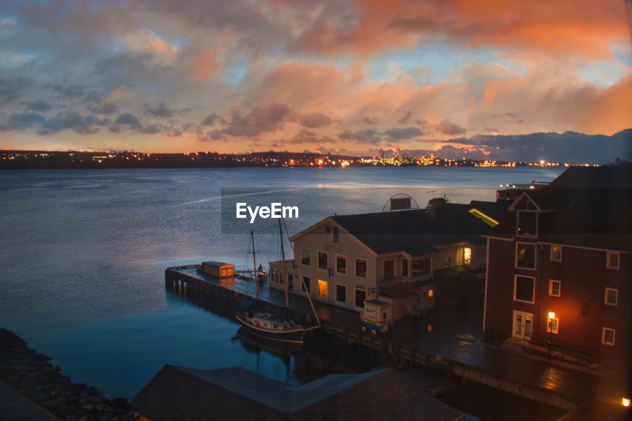 CITY BY SEA AGAINST SKY AT SUNSET