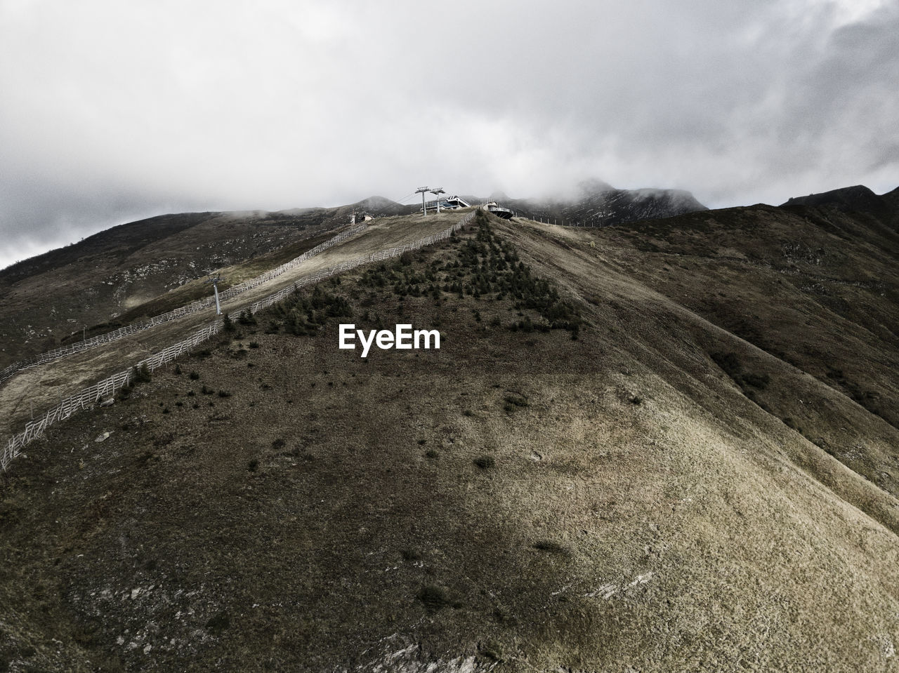 Scenic view of land and mountains against sky