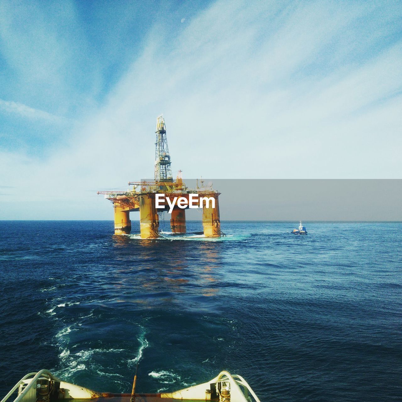 Oil platform at sea against sky