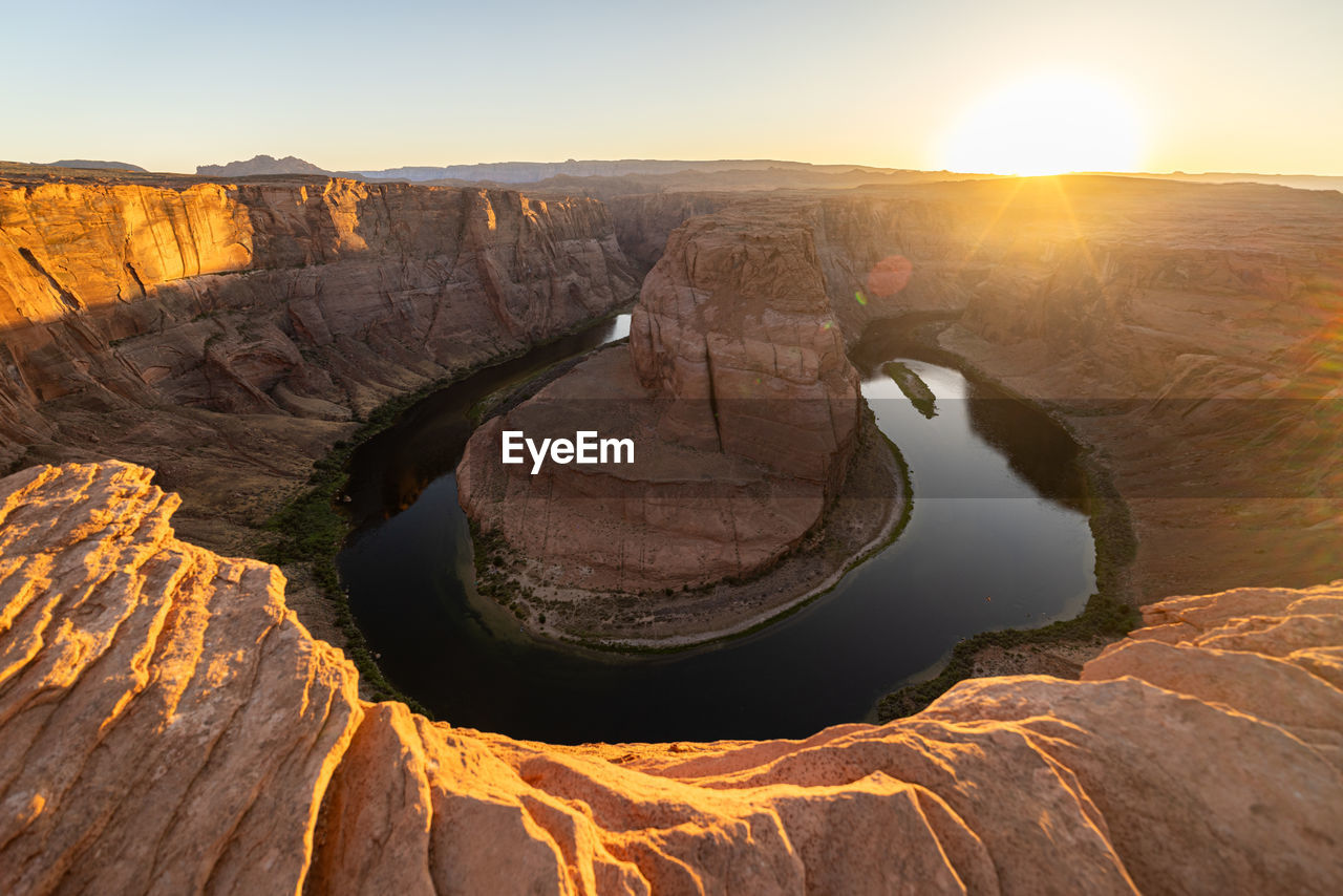 scenic view of sea against clear sky during sunset
