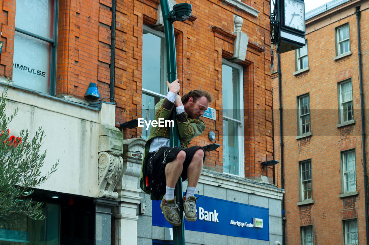 LOW ANGLE VIEW OF MAN AND WOMAN IN BUILDING