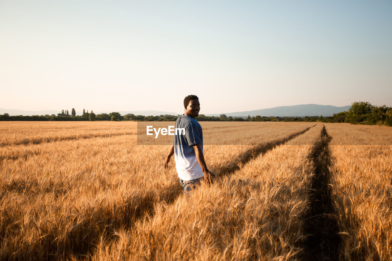 Full length of man standing in field