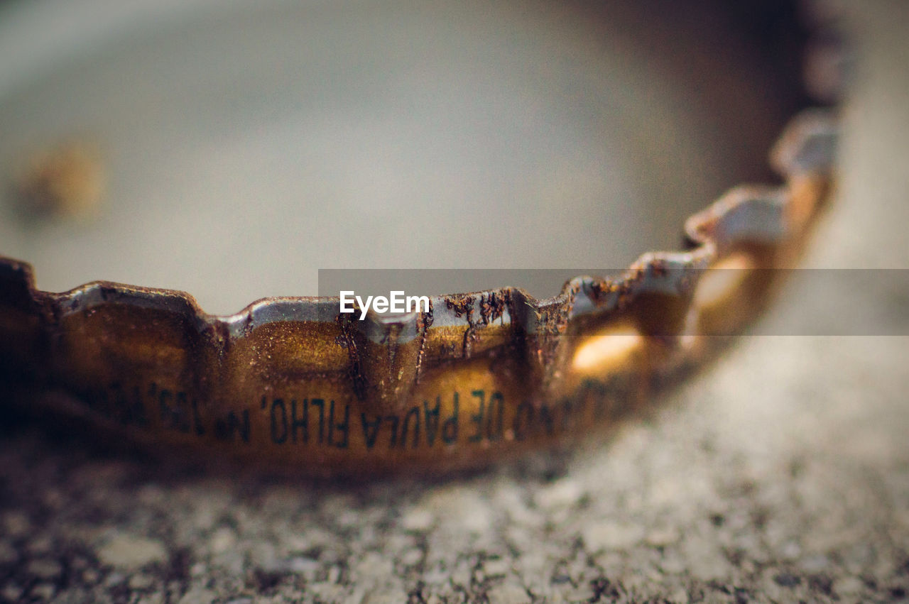 CLOSE-UP OF TEXT ON RUSTY METAL