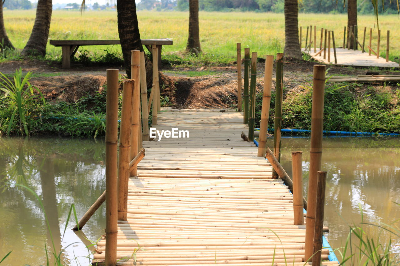 Wooden footbridge on pier over lake